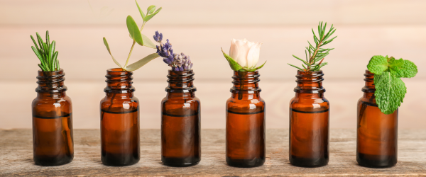 an image of a row of brown bottles with flowers in them