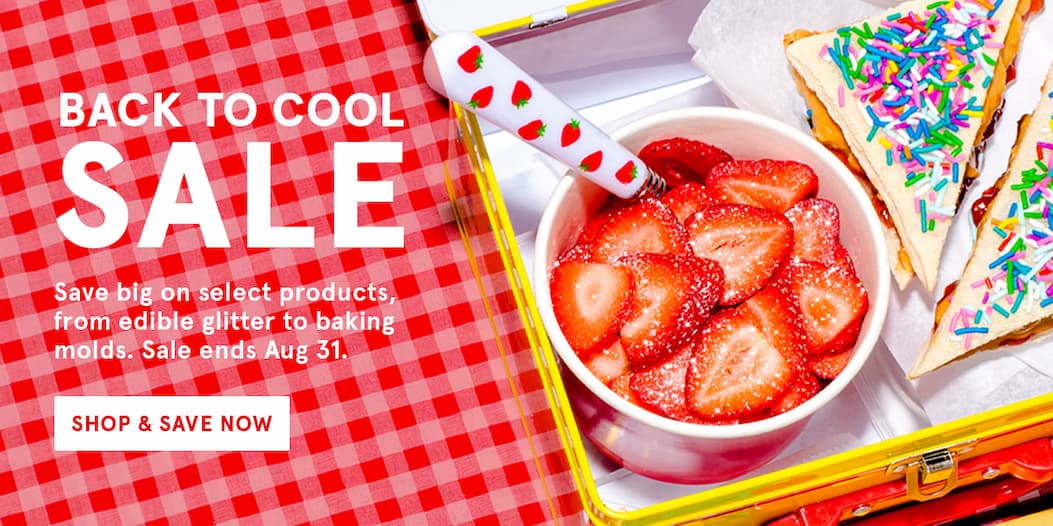 An image of a lunchbox with glitter covered strawberries and a peanut butter and jelly sandwich topped with sprinkles. Text that says "back to cool sale"! Save on select Fancy products until Aug. 31. 
