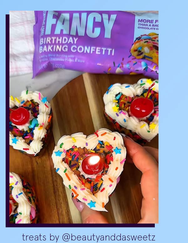An image of heart shaped cookies filled and topped with Birthday baking confetti. 