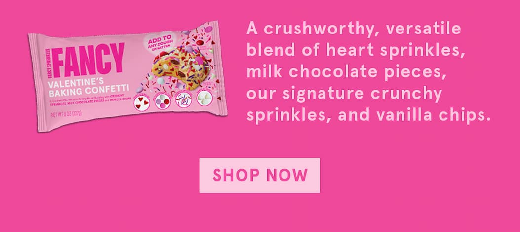 Next to the pink Baking Confetti packaging, it says "a crushworthy, versatile blend of heart sprinkles, milk chocolate pieces, our signature crunchy sprinkles, and vanilla chips. Shop now! 