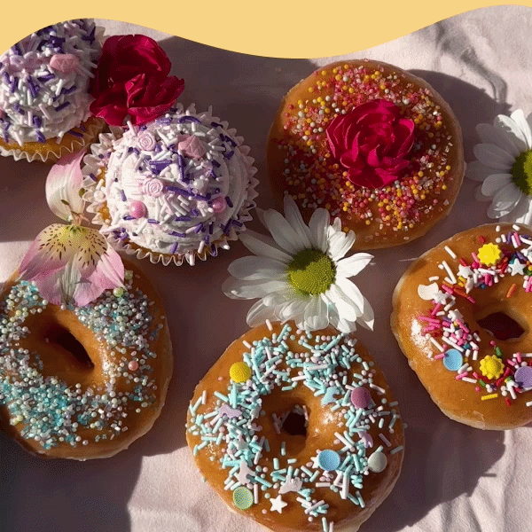 A table of donuts and cupcakes decorated with Fancy Sprinkles