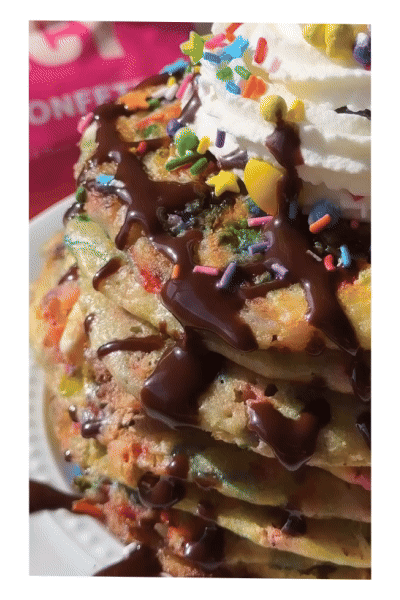 A gif of a stack of colorful pancakes that had Fancy Rainbow Baking Confetti mixed into the batter.