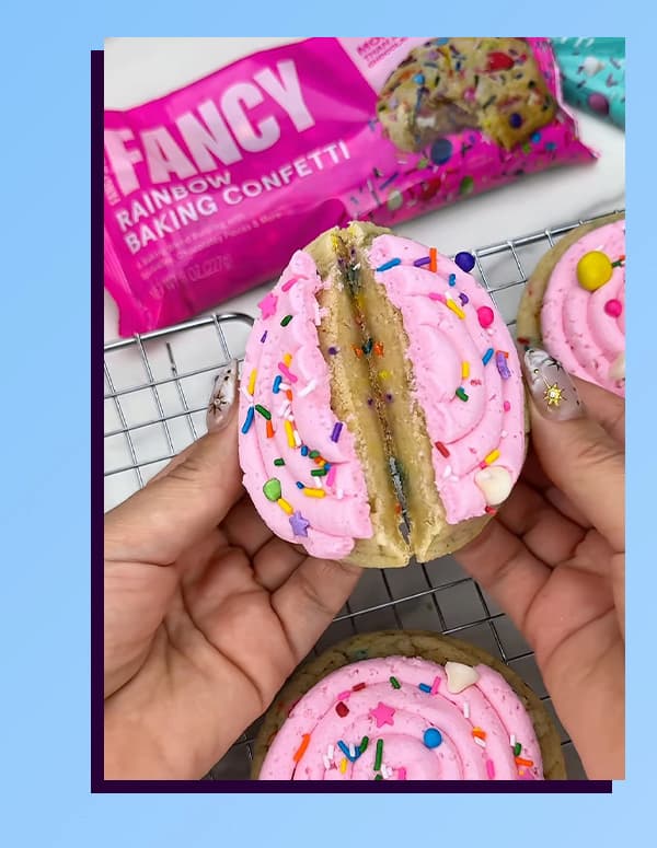 An image of a frosted cookie topped with Rainbow baking confetti. 