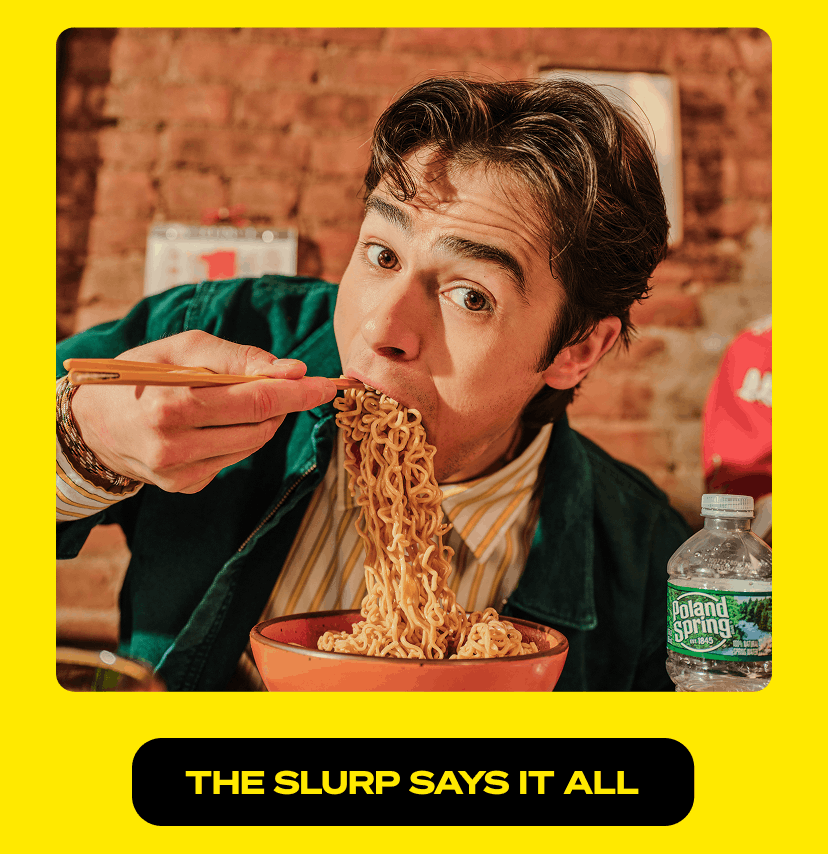 an image of a man eating noodles