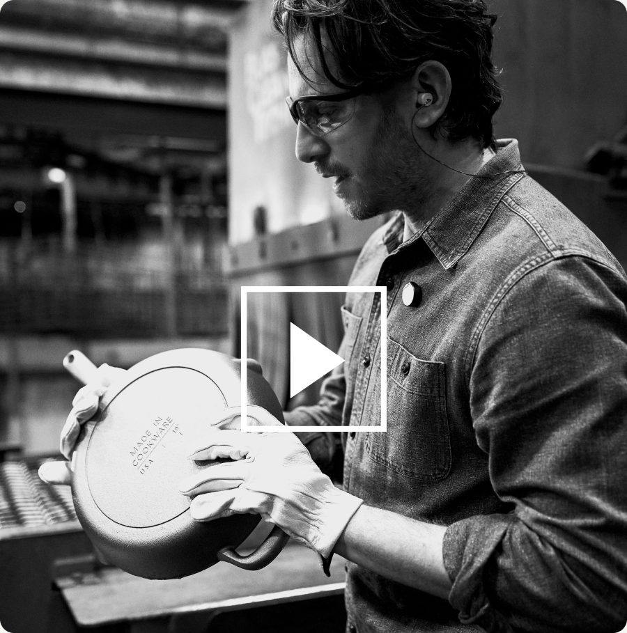Craftsman inspecting a cast iron skillet at the foundry
