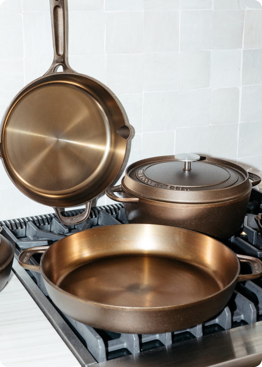 Seasoned cast iron cookware set on a gas stovetop
