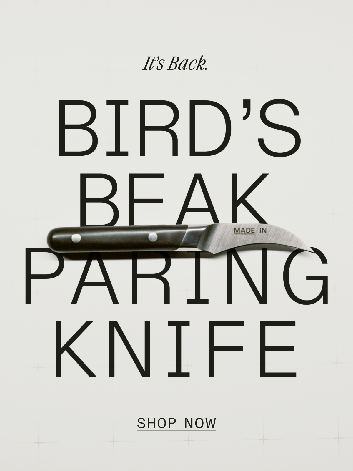 Back In Stock: The Bird's Beak Paring Knife. Black knife with curved blade on grey background. SHOP NOW