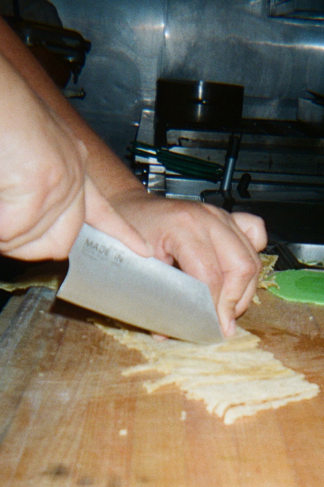an image of a person cutting up food on a wooden cutting board