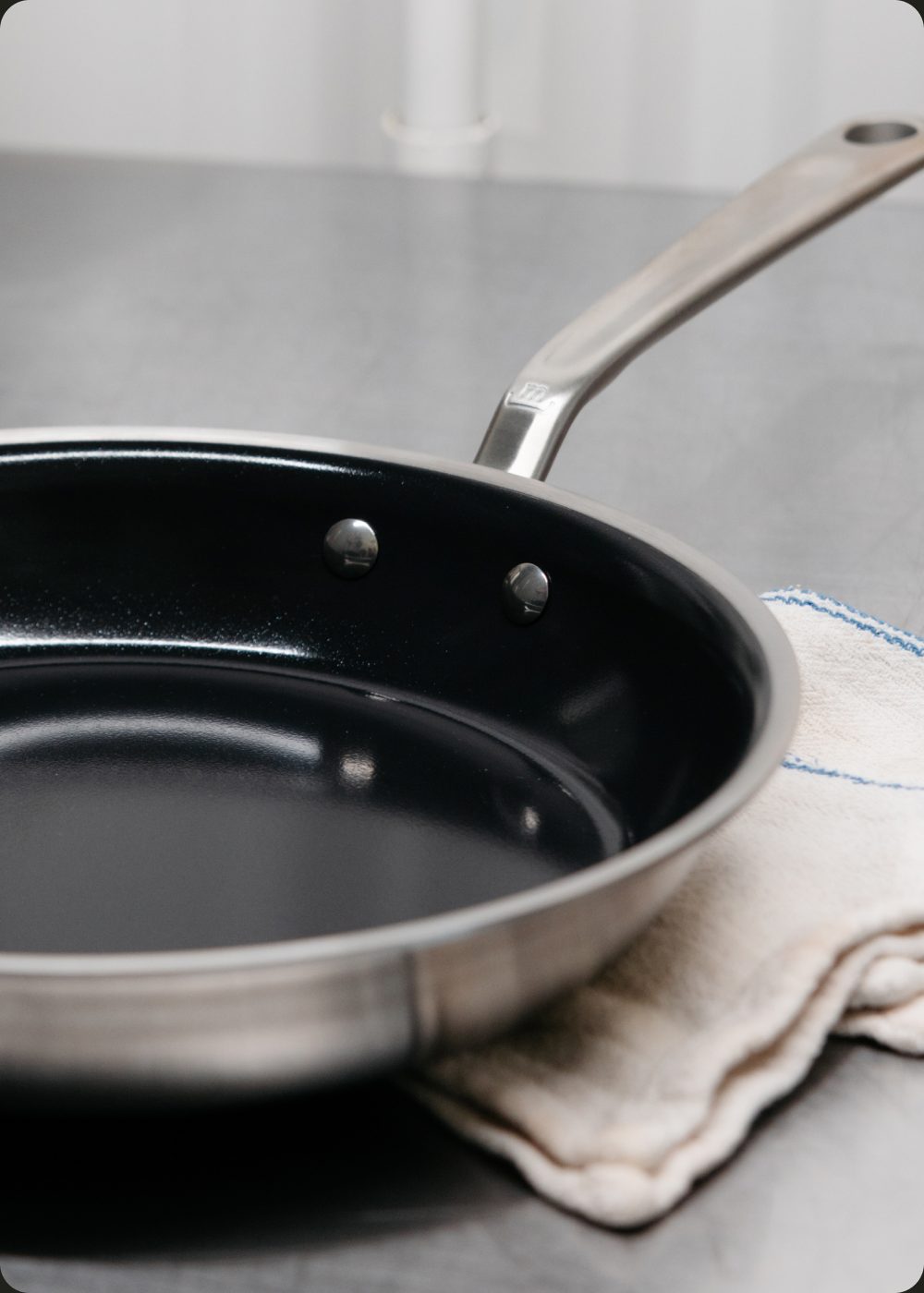 CeramiClad 2.0 frying pan resting on a linen cloth on a countertop
