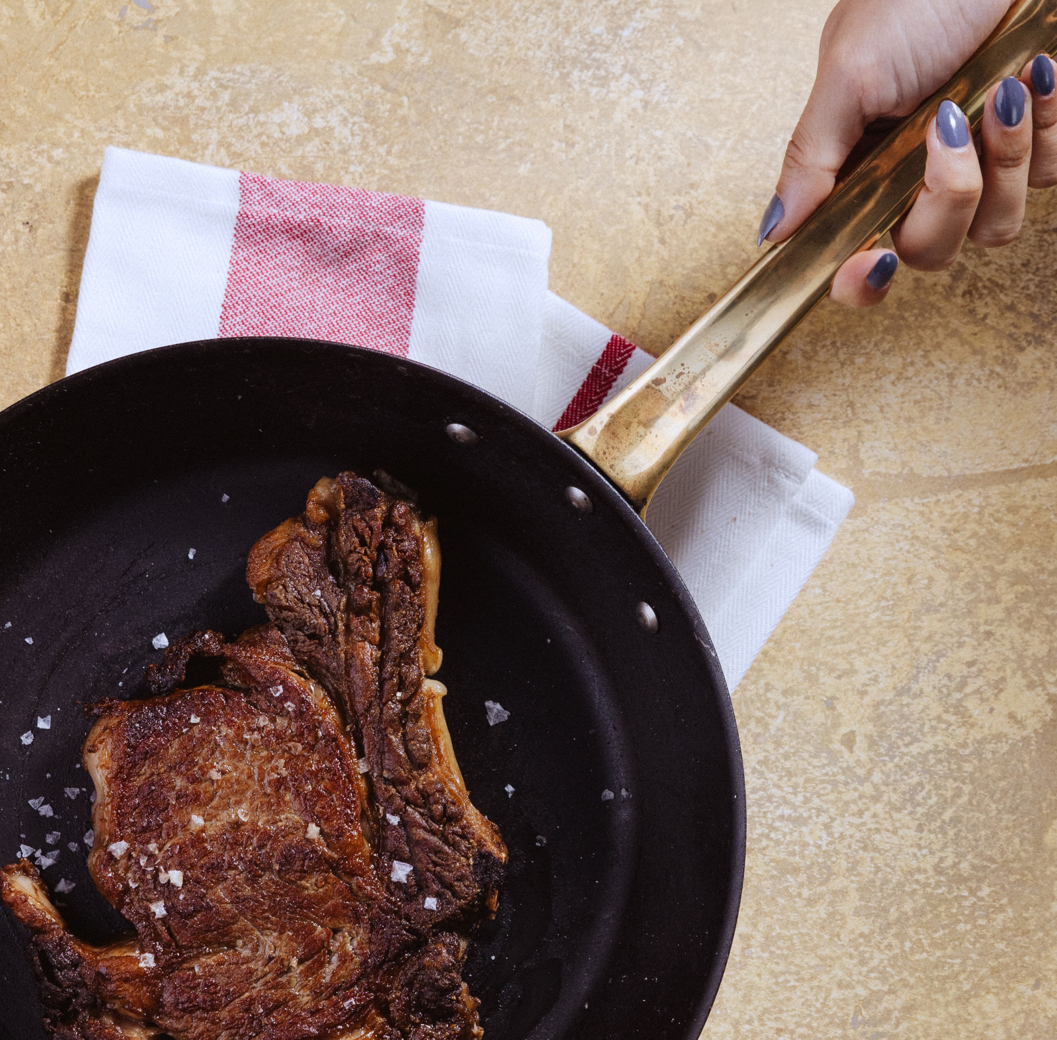 A steak sizzling in a skillet A steak sizzling in a skillet