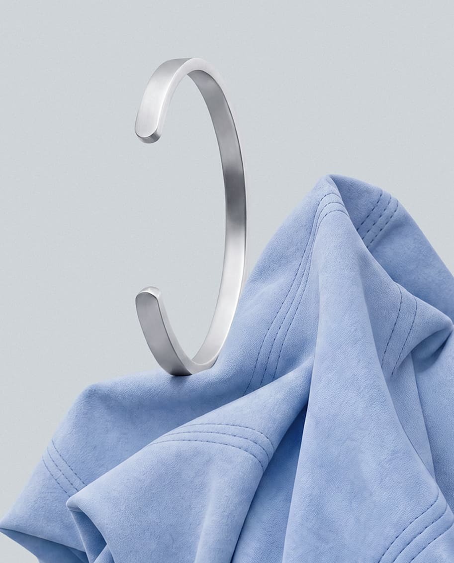 Silver Singular Cuff on blue fabric.