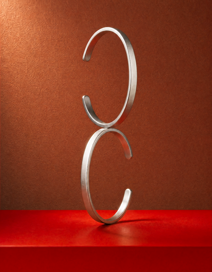Sterling Singular cuffs stacked on a table