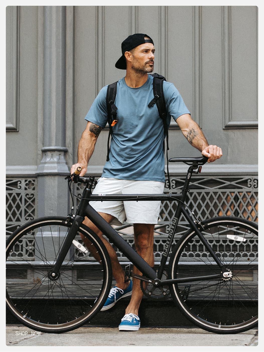 Lifestyle Image of City Dude with a bike in Foundation Shirt and Short