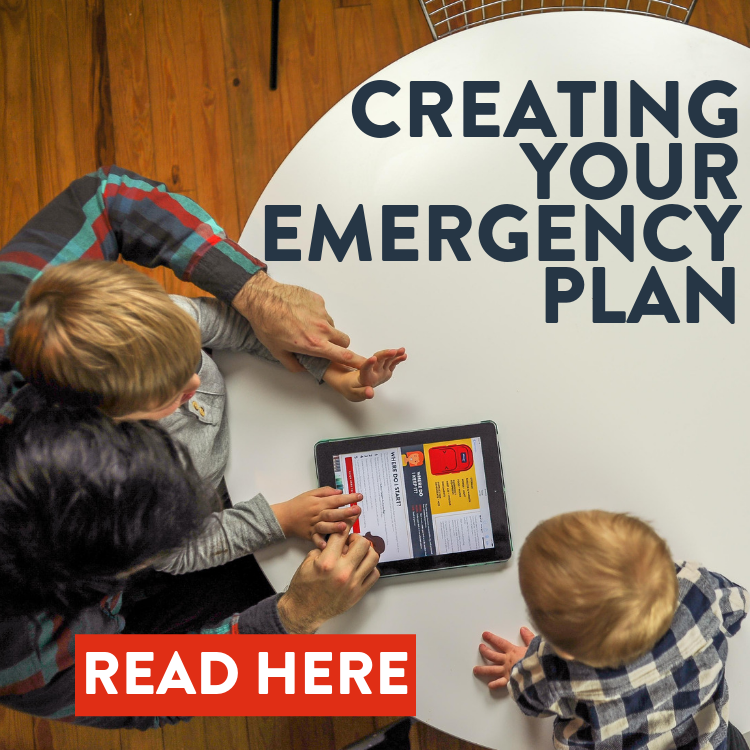 Family sitting around table reading the Redfora Guide to building their Family Emergency Plan