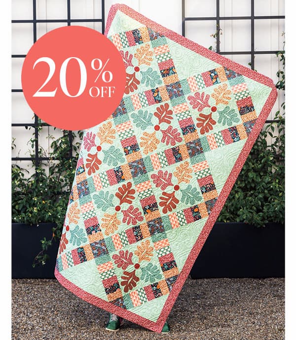 Image: A quilt featuring leafy blocks and patchwork. Text: 20% Off >>