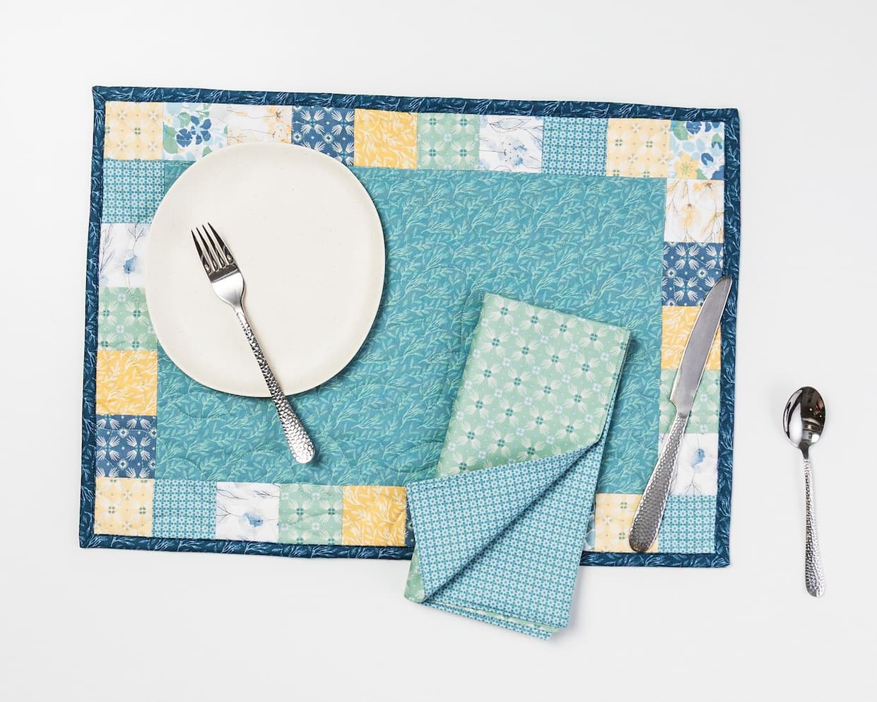 A handmade blue green and yellow placemat