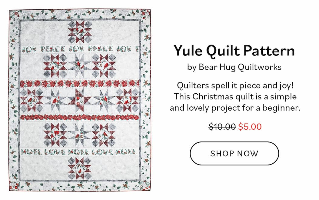 Image: A holiday themed quilt with a white background and red and green blocks. Text: Yule Quilt Pattern by Bear Hug Quiltworks. Quilters spell it piece and joy! This Christmas quilt is a simple and lovely project for a beginner. was $10, now $5. Shop Now >>