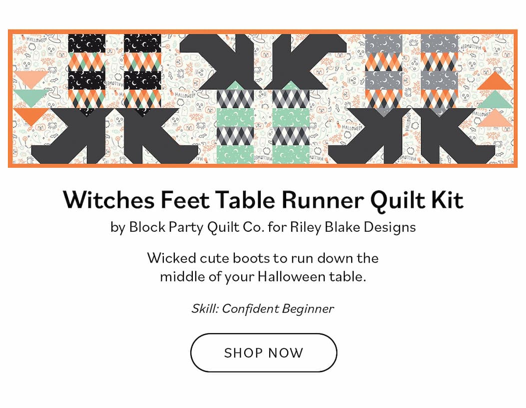 Image: A quilted table runner with witches feet . Text: Witches Feet Table Runner Quilt Kit by Block Party Quilt Co. for Riley Blake Designs. Wicked cute boots to run down the middle of your Halloween table. Skill: Confident Beginner. Shop Now >>