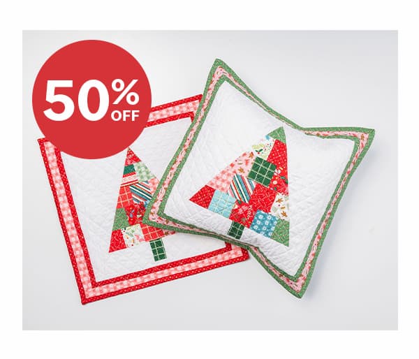 Image: A pillow quilt kit with holiday festive trees. Text: 50% off >>