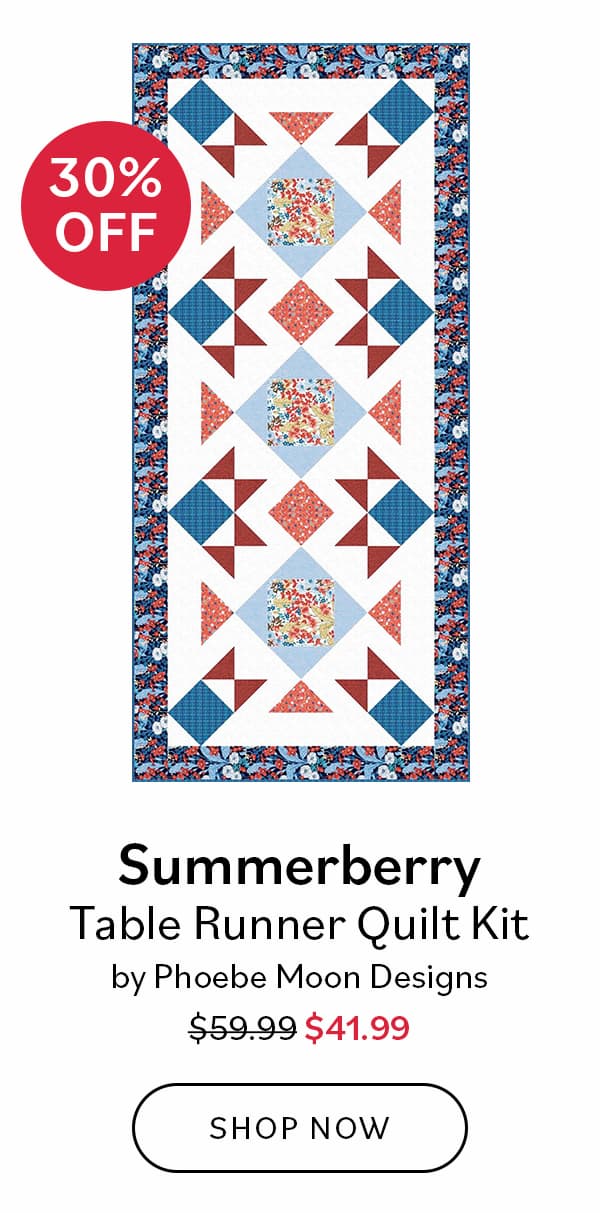 Image: A table runner with red, white, and blue floral blocks. Text: 30% Off Summerberry Table Runner Quilt Kit by Phoebe Moon Designs. Was $59.99, now $41.99. Shop Now >>