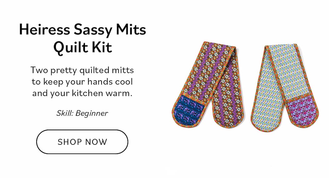 Image: A pair of long oven mitts. Text: Heiress Sassy Mitts Quilt Kit. Two pretty quilted mitts to keep your hands cool and your kitchen warm. Skill: Beginner. Shop Now >>