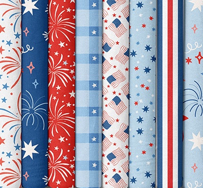 Quilting fabrics with patriotic prints in reds, whites, and blues. >>