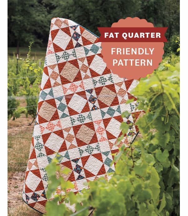 Image: A patchwork quilt with rusty reds and teals. Text: Fat Quarter Friendly Pattern >>