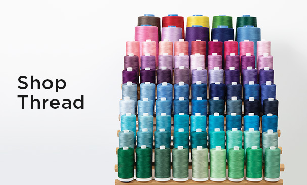 Text: Shop Thread Image: a colorful assortment of thread spools