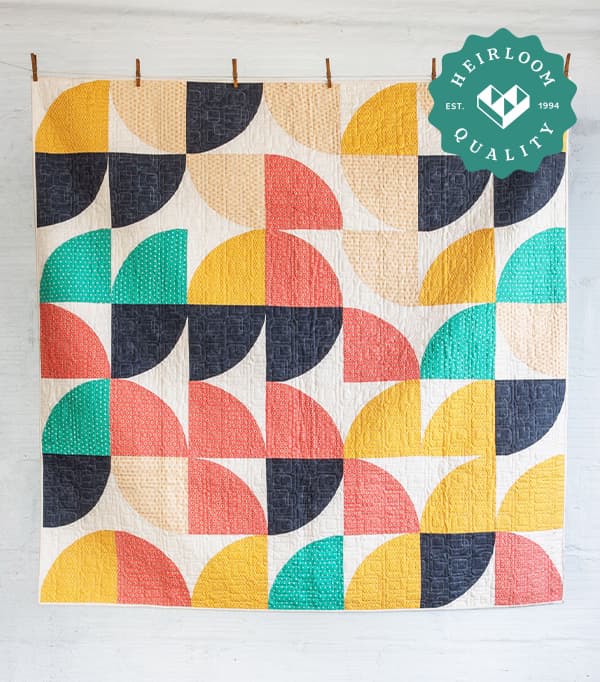 Picture of colorful quilt with shapes hanging