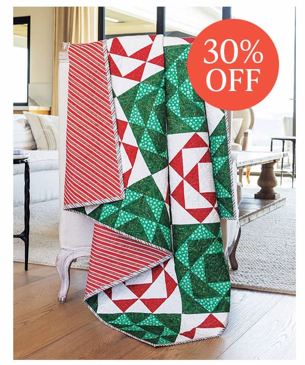  Image: A red, green, and white quilt draped over a chair. Text: 30% off >>