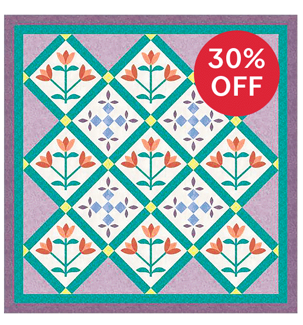 Image: A square quilt with floral blocks and purple and green trims. Text: 30% off >>