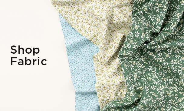 Text: Shop Fabric Image: a colorful floral fabric twisted into a swirl