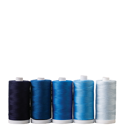 A set of thread cones in different shades of blue. >>