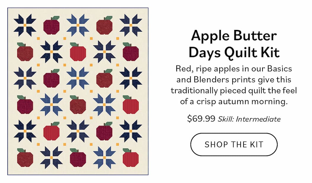 Image: A cream quilt with apple and star blocks. Text: Apple Butter Days Quilt Kit. Red, ripe apples in our Basics and Blenders prints give this traditionally pieced quilt the feel of a crisp autumn morning. $69.99. Skill: Intermediate. Shop the Kit >>