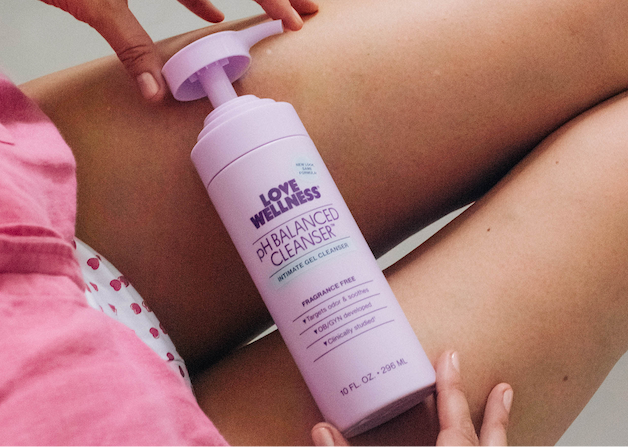 pH Balancing Cleanser resting against a person’s thighs