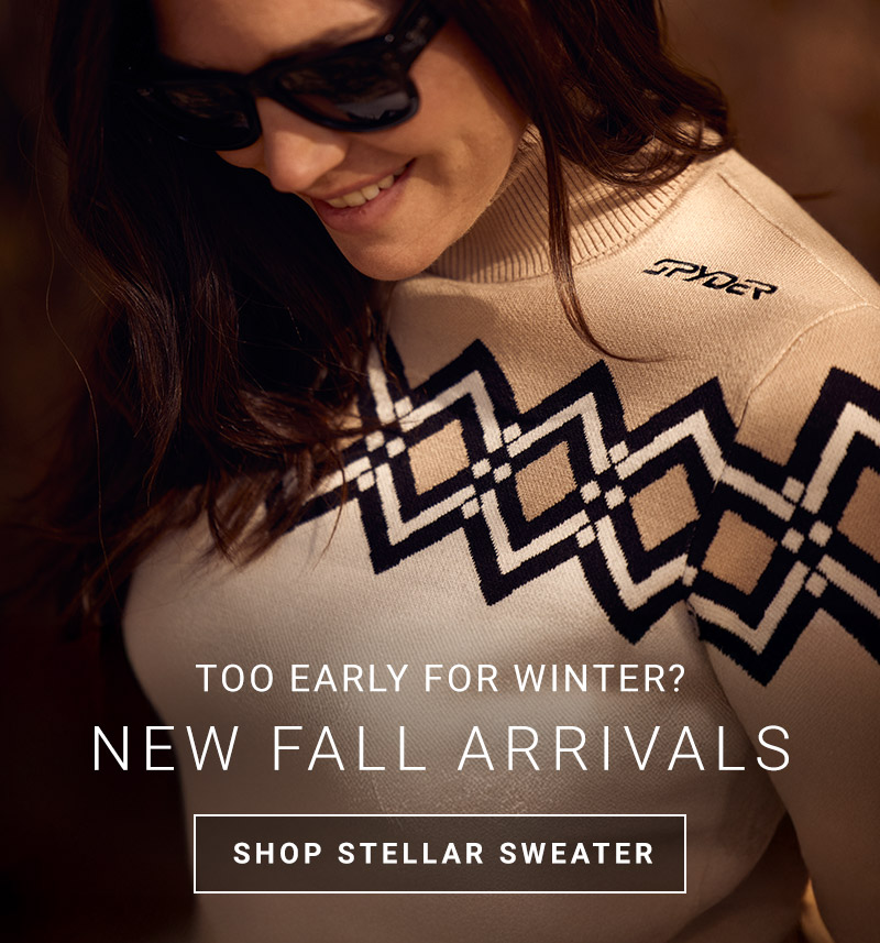 Close up shot of woman wearing a patterned sweater in tan and white. Message: Too Early for Winter? New Fall Arrivals - Shop Stellar Sweater