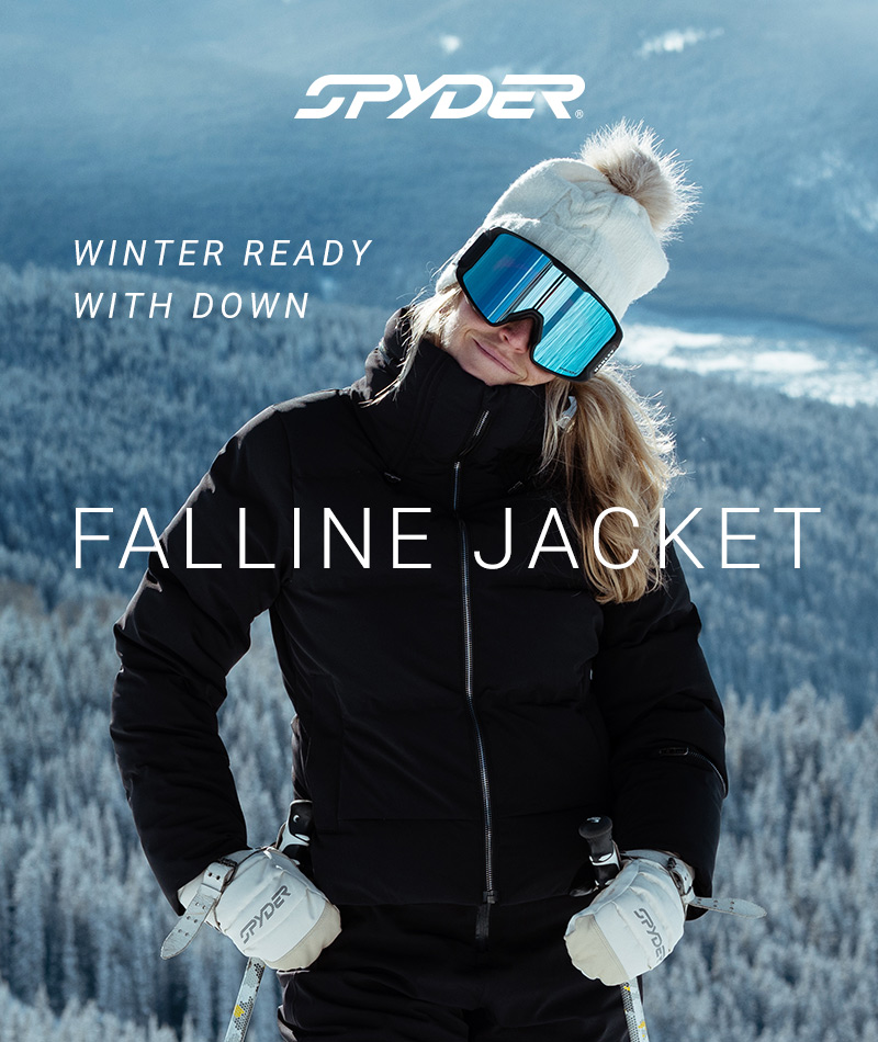 Woman with skis wearing a black down jacket against a blue winter forest.  Spyder logo. Message: Winter Ready With Down. Falline Jacket.