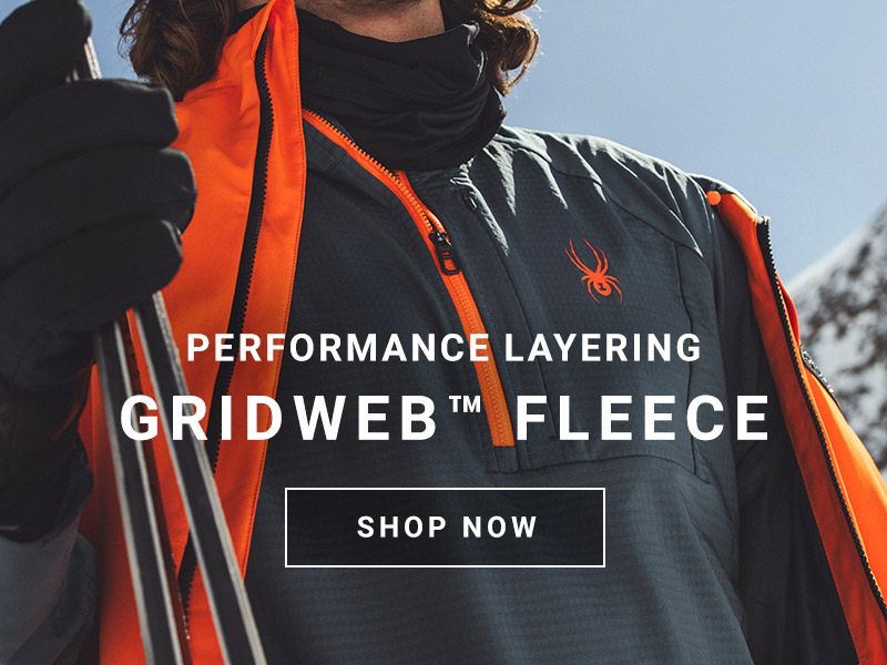 A person wearing a gray and orange fleece jacket Message: Performance Layering Gridweb™ Fleece. Shop Now.