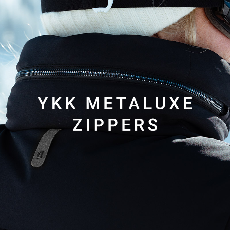 Detail shot of shiny, elevated zippers. Message: YKK Metaluxe Zippers.