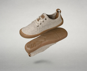 Image of 4 products: A light blue fabric Wildling minimalist shoe, a cream-colored Wildling minimalist shoe with a light, abstract leopard-style pattern a beige Wildling minimalist shoe made of a textured natural fabric and a  light green fabric Wildling