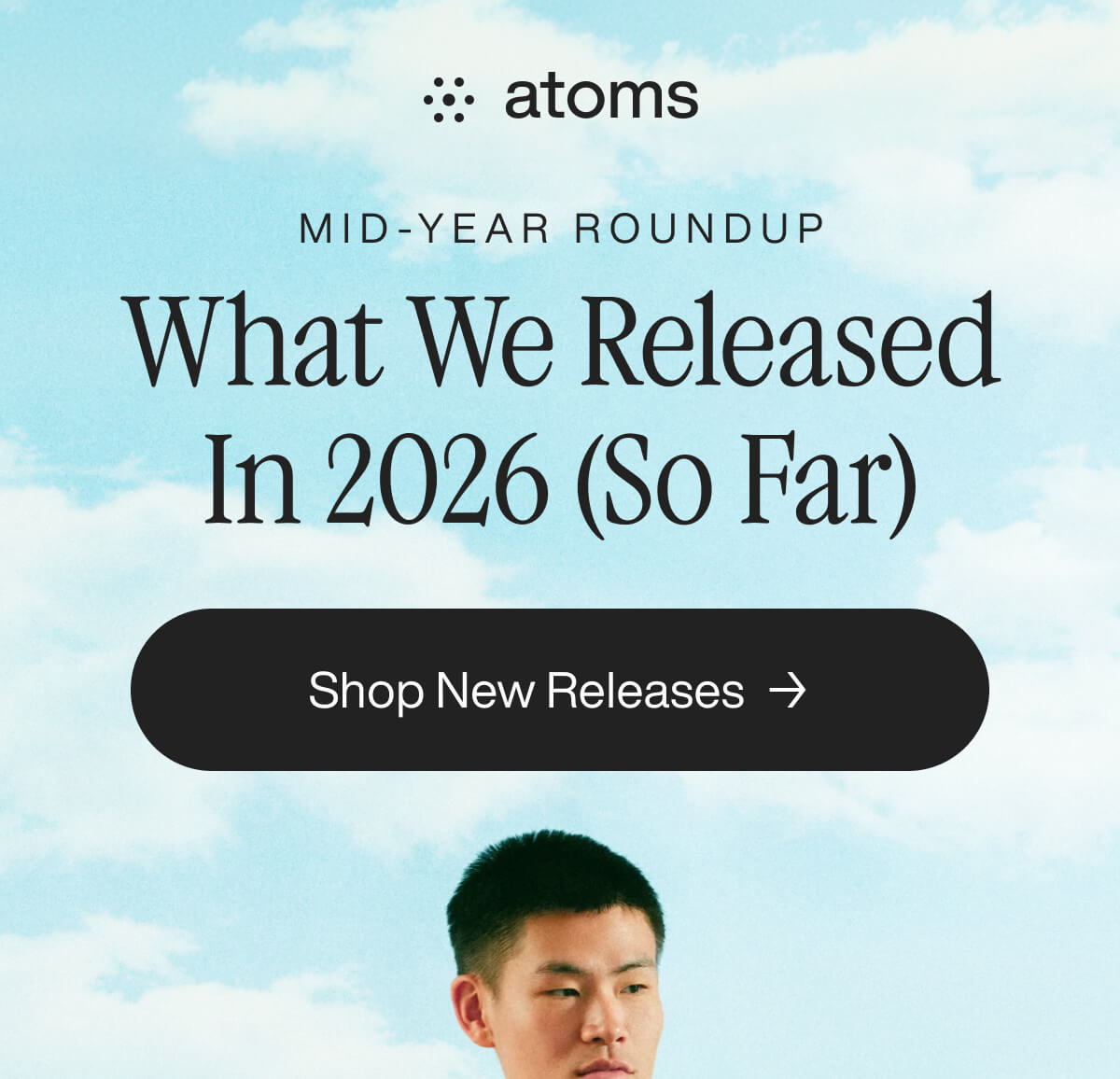 Atoms mid-year roundup 2026 release highlights with a 'Shop New Releases' button. Blue sky background with a person below.
