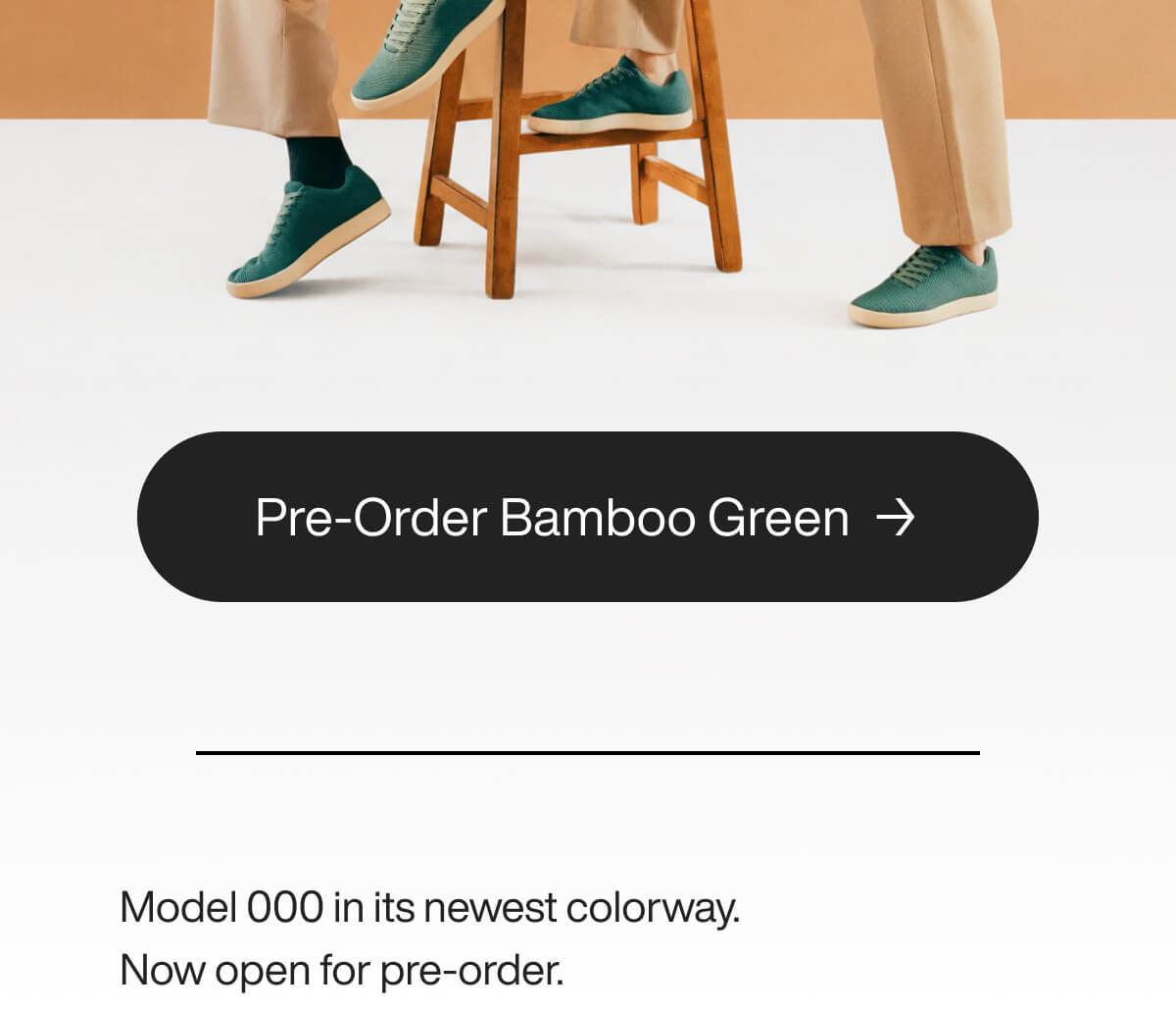 Two people sit on stools wearing tan pants and green sneakers. A button below says, "Shop Bamboo Green." Text reads, "Model 000 in its newest colorway. Now open for pre-order."