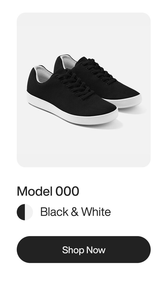 Black and white sneakers, Model 000, with a sleek design, displayed on a white background. Shop now button below.