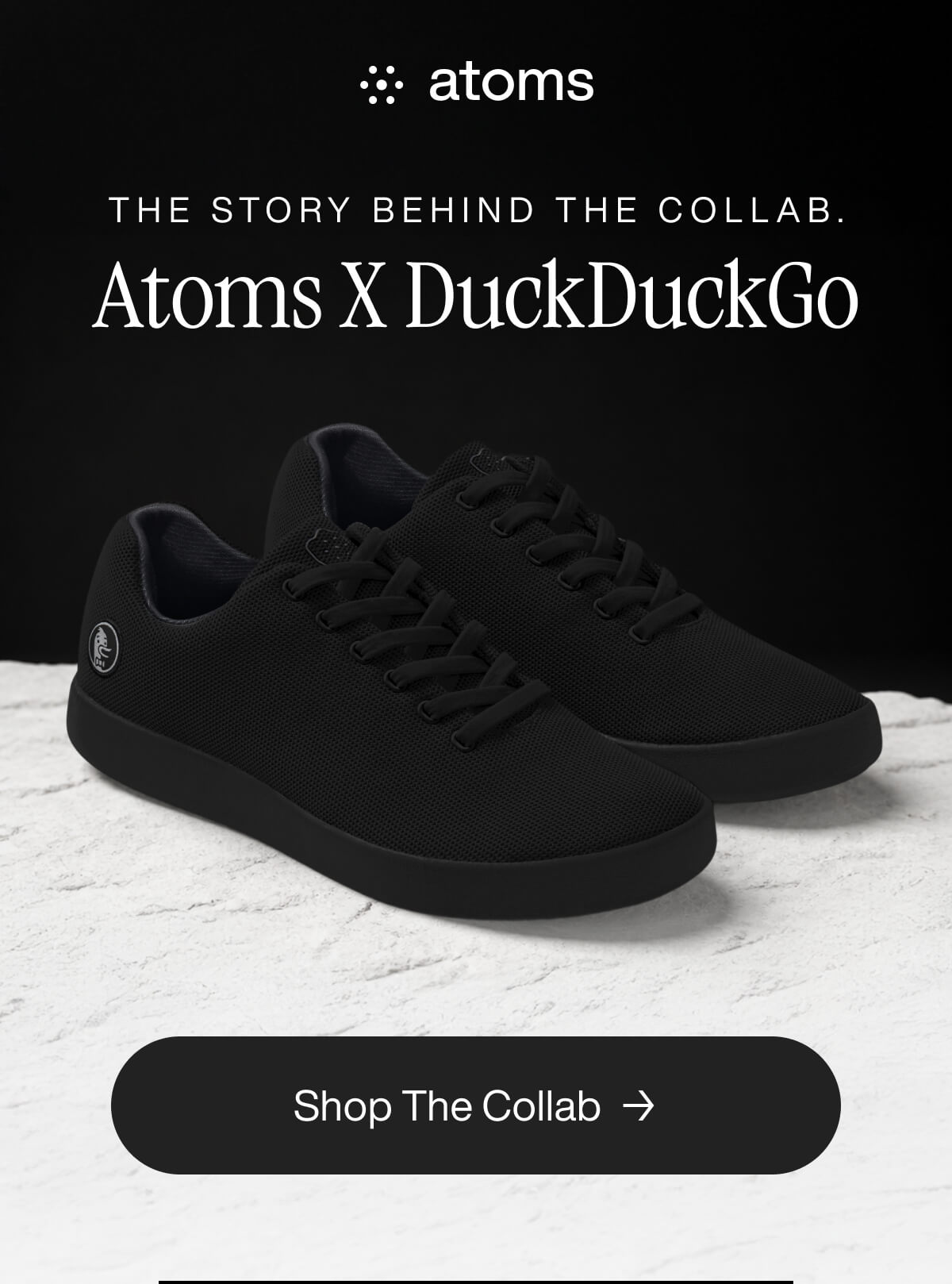 Black sneakers displayed on a light surface with the text "Atoms X DuckDuckGo" above and "Shop The Collab" button below, conveying a sleek collaboration.