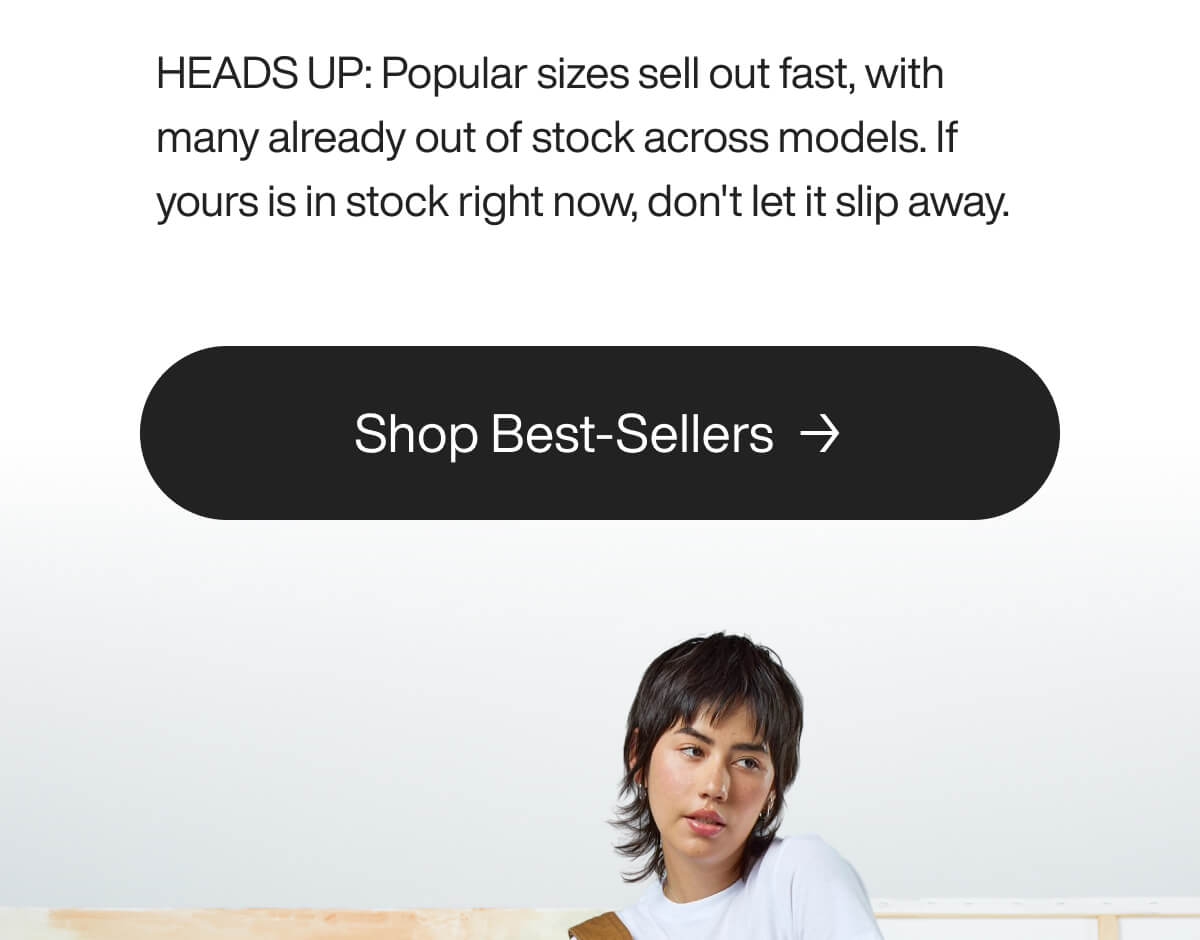 A person with a dark shaggy haircut looks forward against a plain white background.