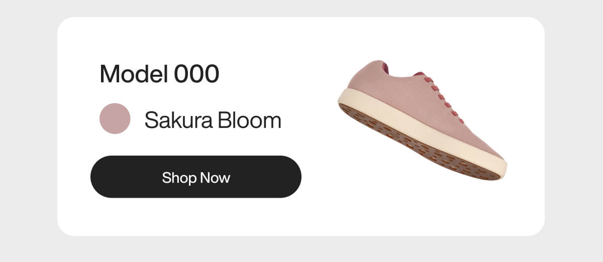 "Model 000 Sakura Bloom sneaker in pink with white sole. "Shop Now" button displayed."