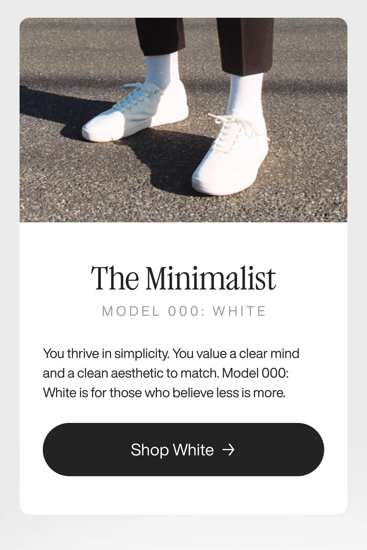 "White sneakers on pavement, promoting "The Minimalist" Model 000: White, emphasizing simplicity and clean aesthetics."