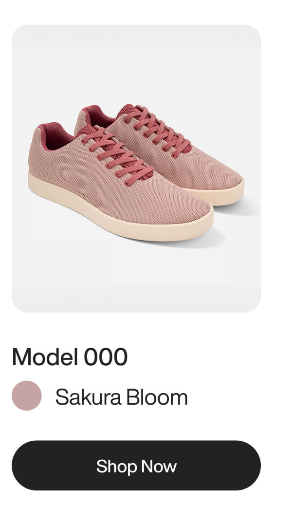 Pink sneakers, Model 000 in Sakura Bloom, with white soles on a white background. "Shop Now" button below.