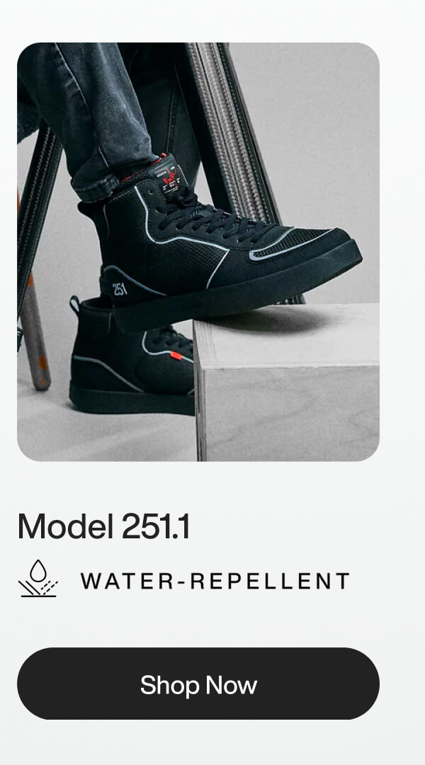 A person wearing black high-top, water-repellent sneakers, Model 251.1, with white accents, rests their foot on a gray block. Text reads "Shop Now."
