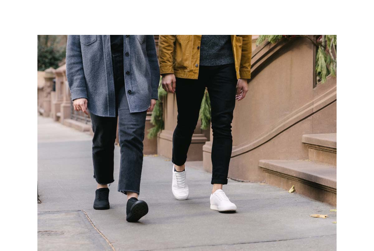 Two friends walking and wearing Atoms shoes.